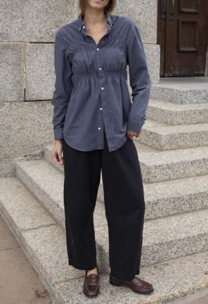 woman in dark grey button-up and black pants