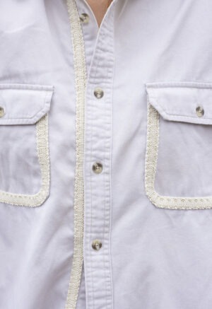 woman in cream button-up and brown pants