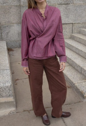 Made out of a men's button-up and shortened with side slits cut up the sides with tie in the front to wrap around. Made out of a pale yellow cotton fabric.