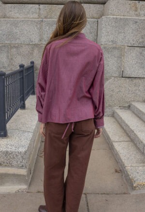 Made out of a men's button-up and shortened with side slits cut up the sides with tie in the front to wrap around. Made out of a pale yellow cotton fabric.